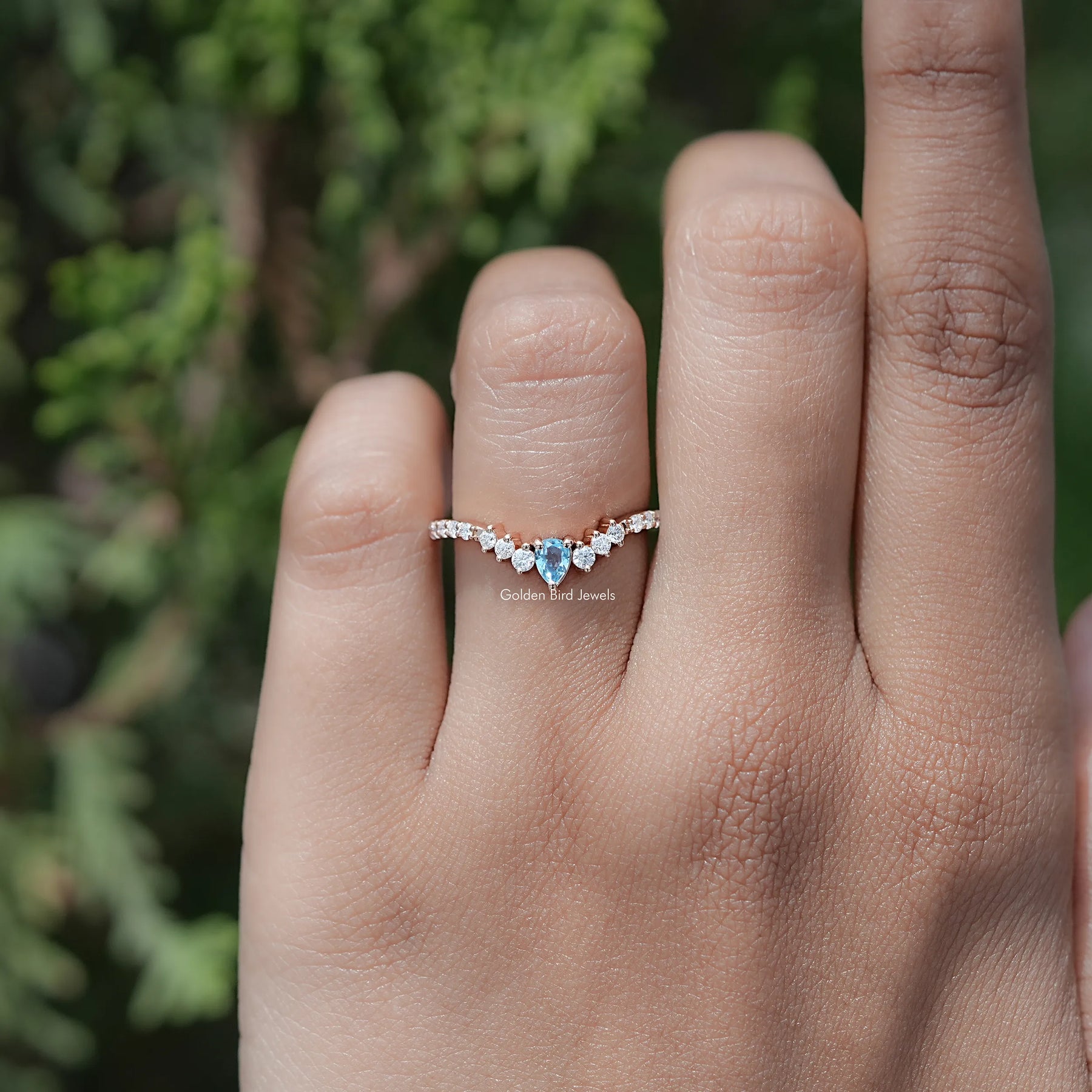 In finger view of Pear and Round Cut Moissanite Solitaire Ring