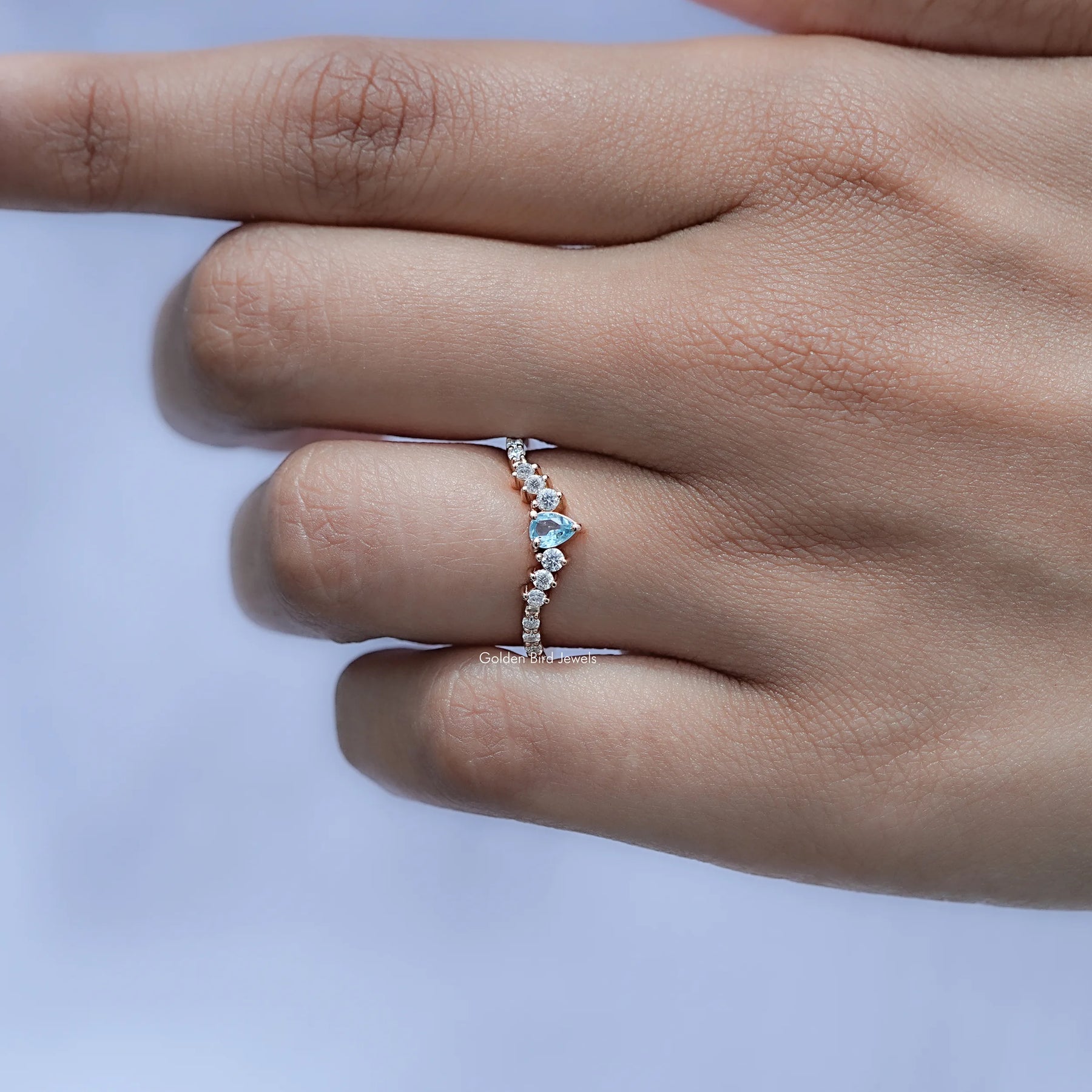 View of Pear and Round Cut Moissanite Ring in prongs setting