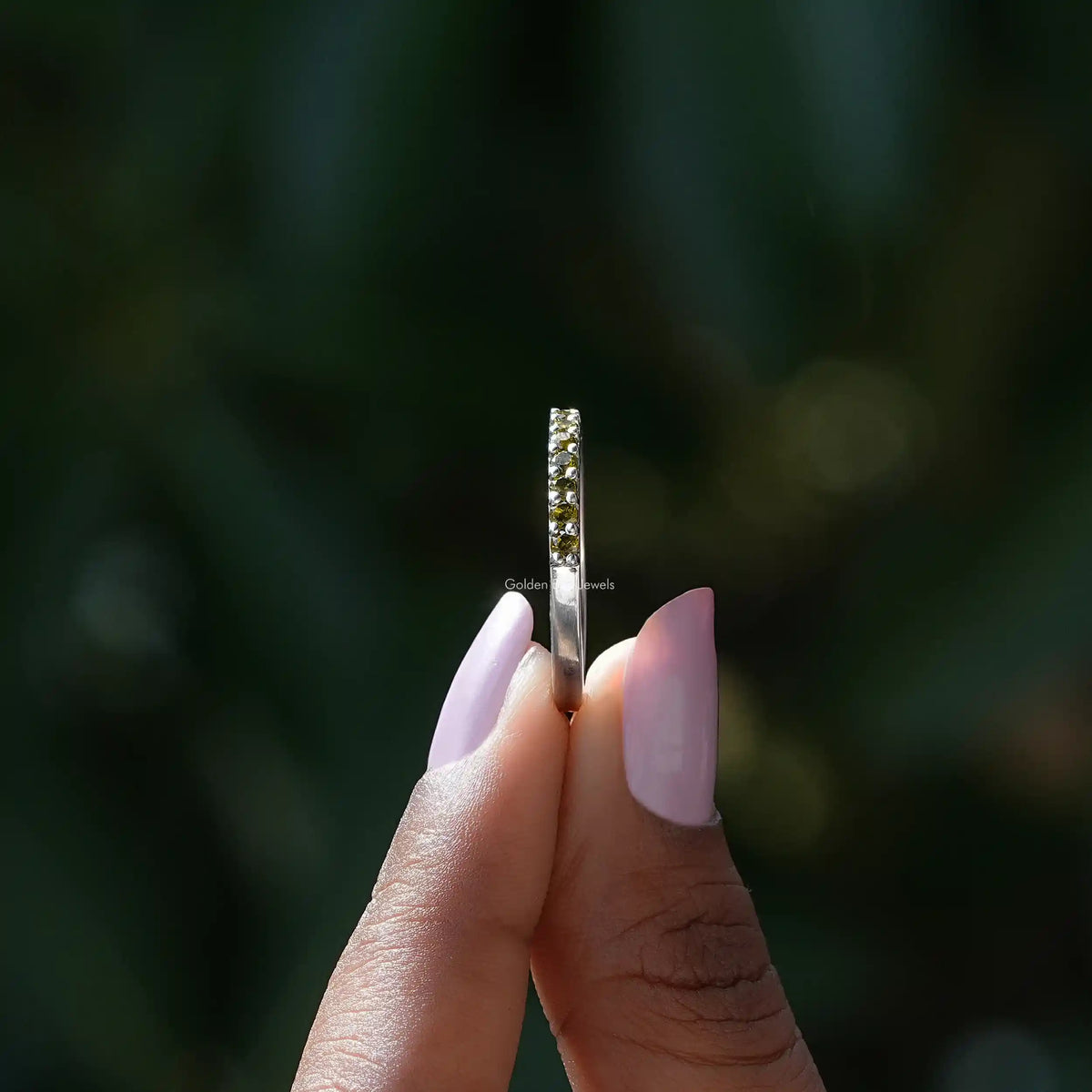 Side view of August Birthstone Peridot Green Round Eternity Band