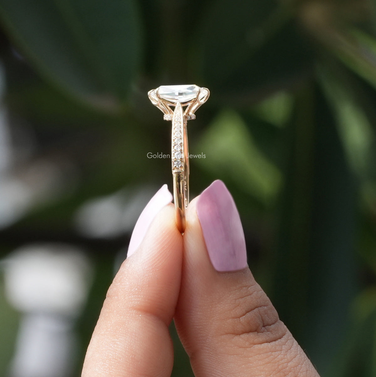 Side View of Portrait Hexagon Cut Moissanite Ring In two fingers