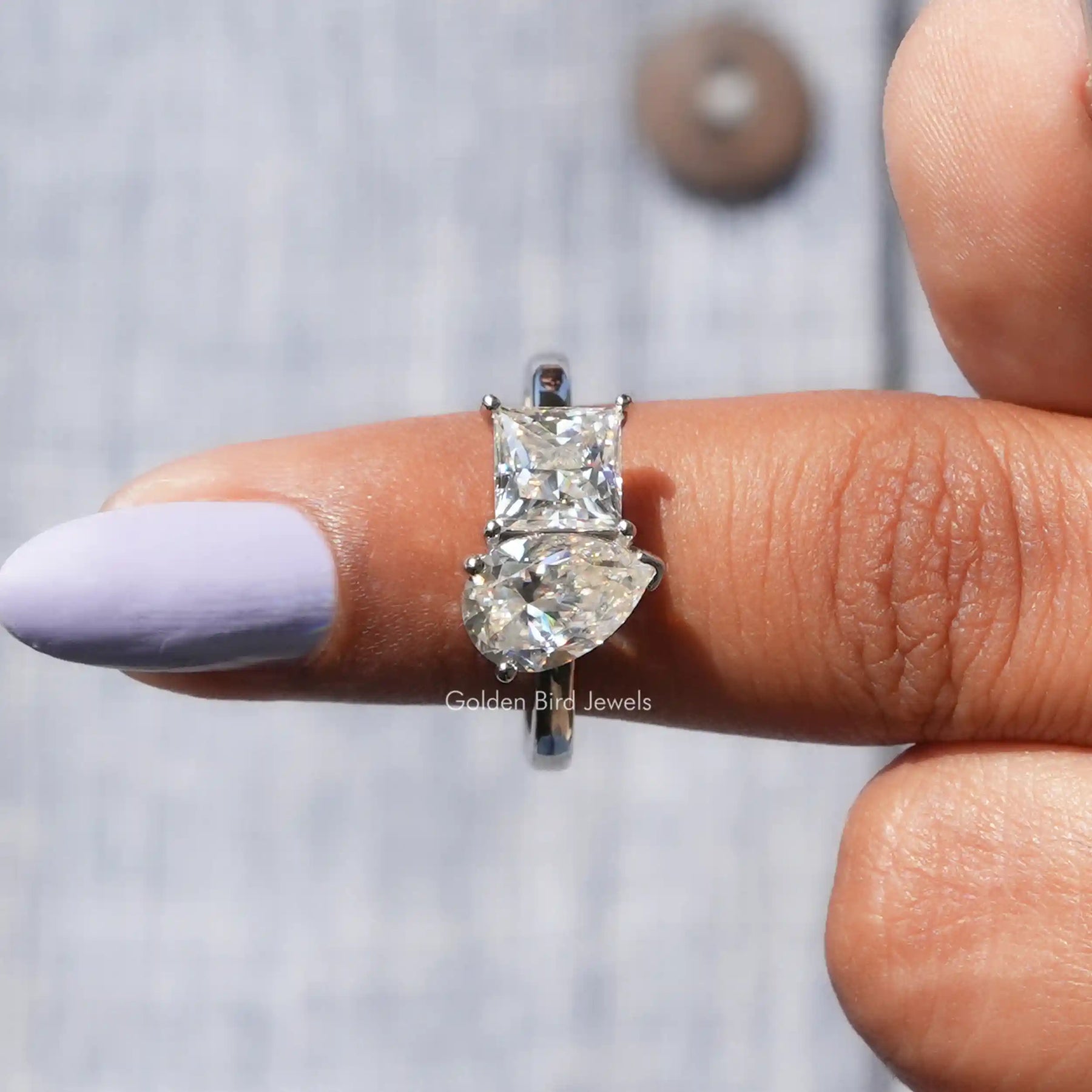 In finger front View of Pear And Princess Cut Moissanite Ring