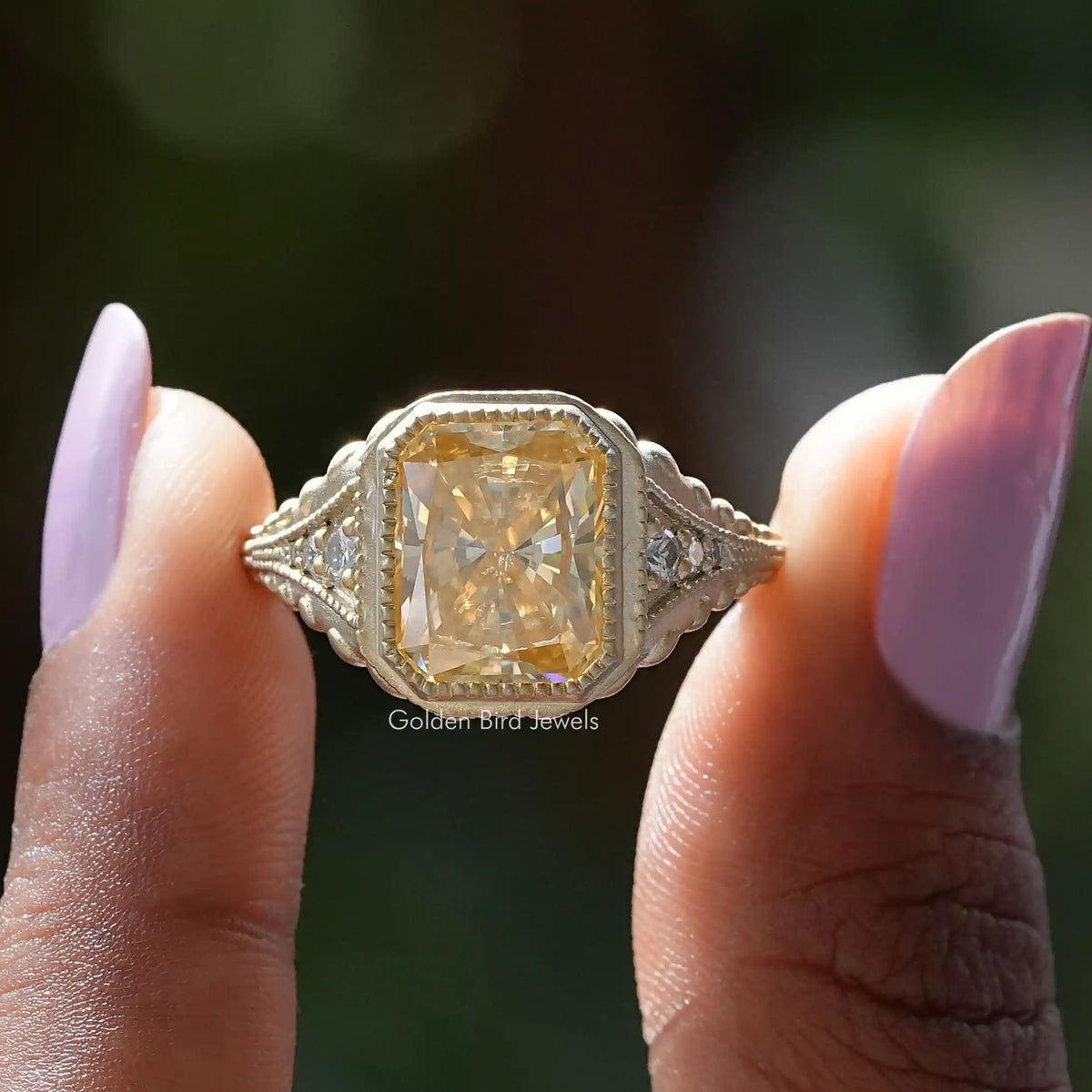 Two fingers holding the Radiant Cut Moissanite Accent Stone Ring