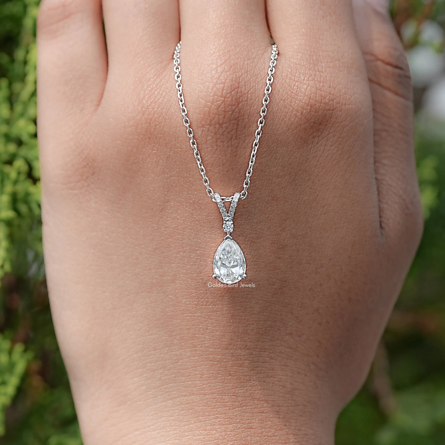 Close View Of Round And Pear Cut solitaire pendant in Secure Setting