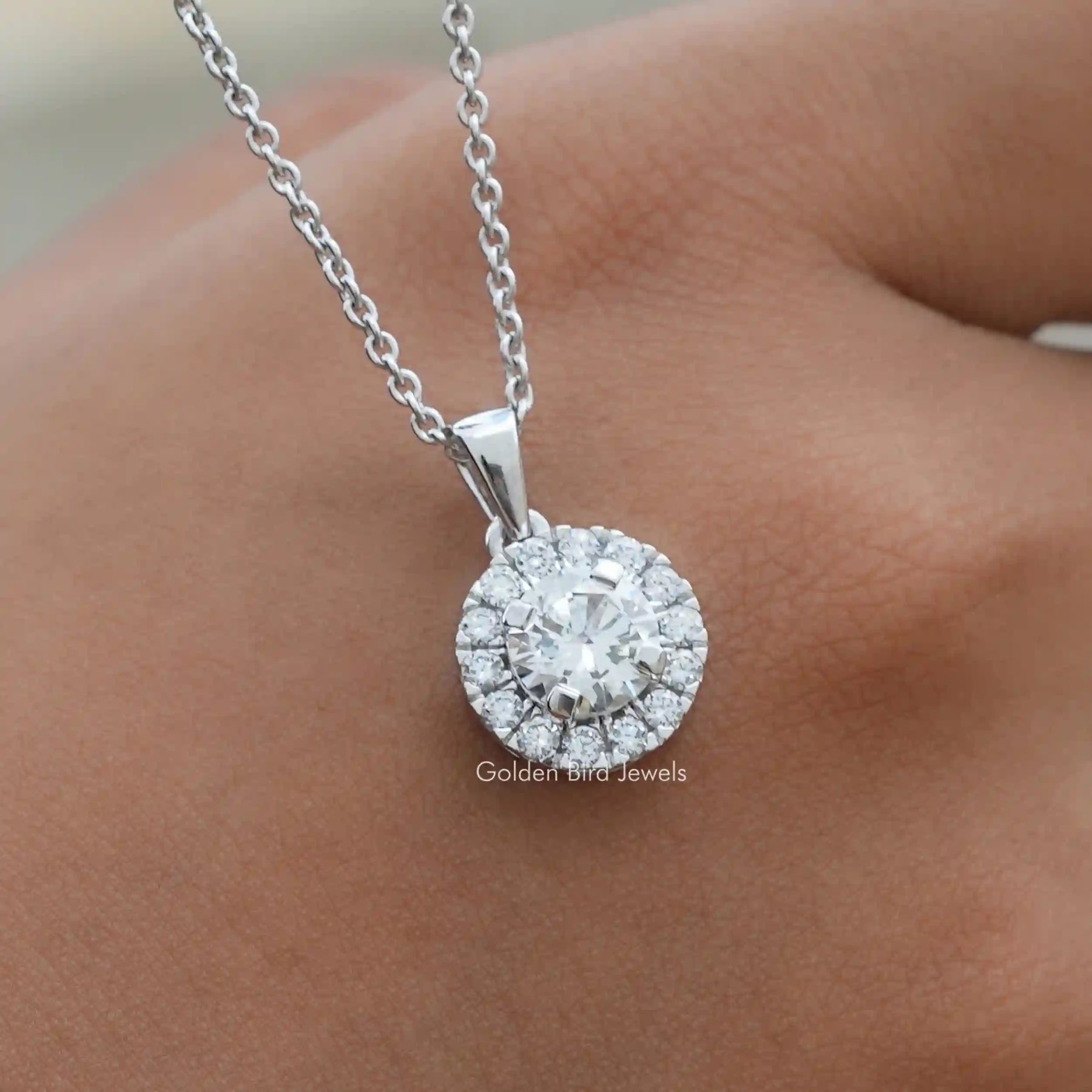 In hand showing view of lab diamond pendant