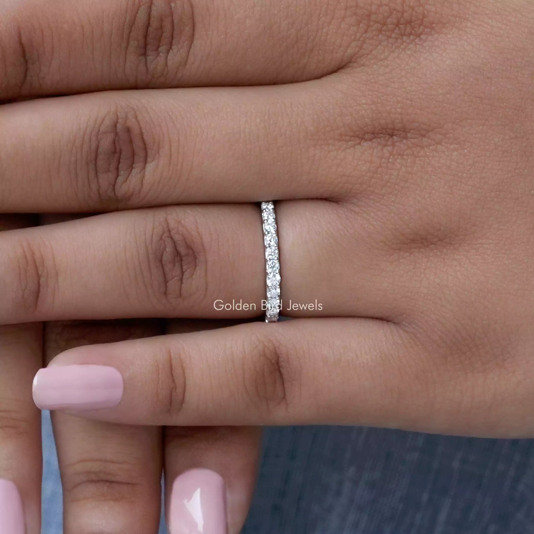 In finger front view of Round Cut Moissanite Solitaire Ring in unique shape