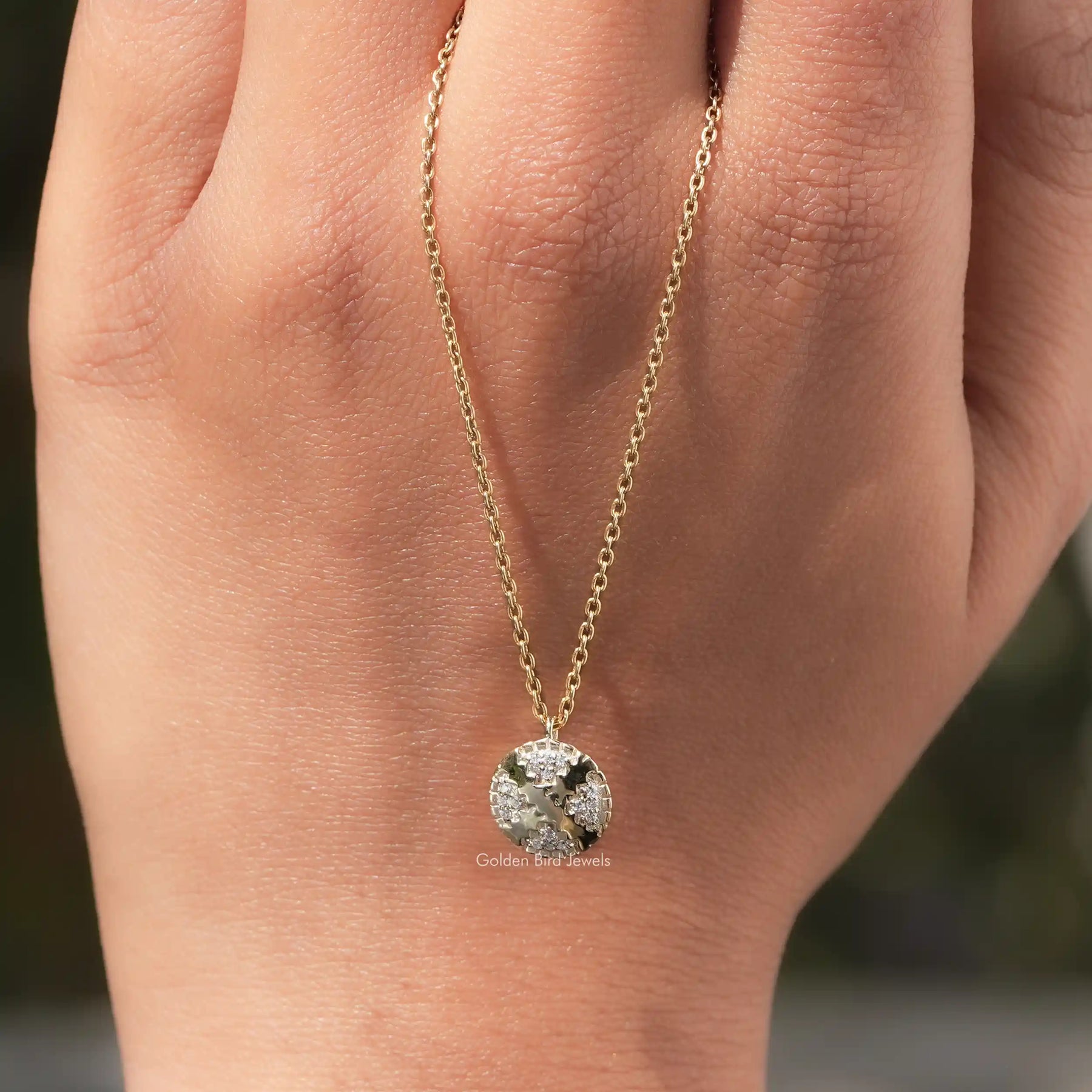 In hand showing view of moissanite pendant