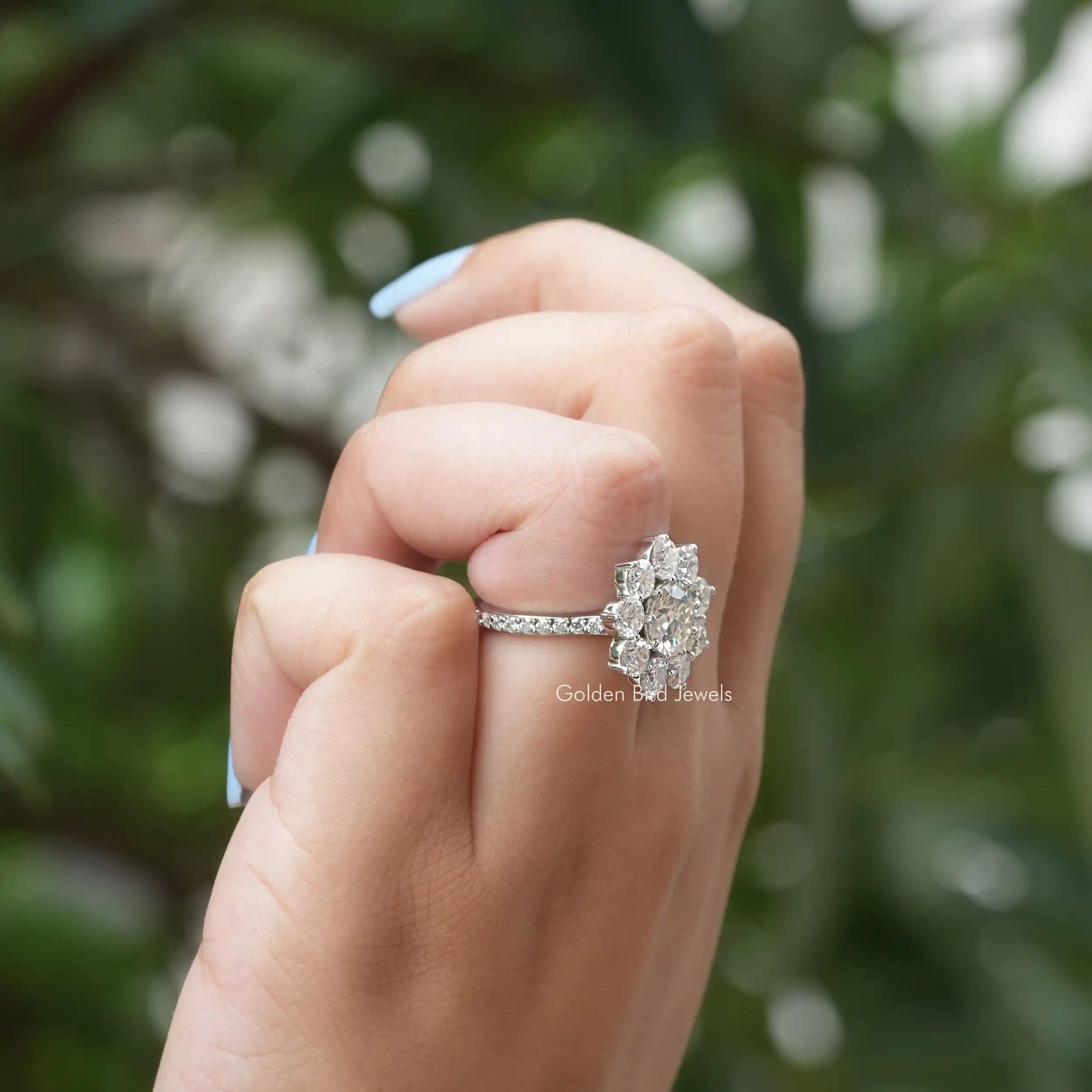 View of Round Cut Moissanite Floral Halo Ring In Finger