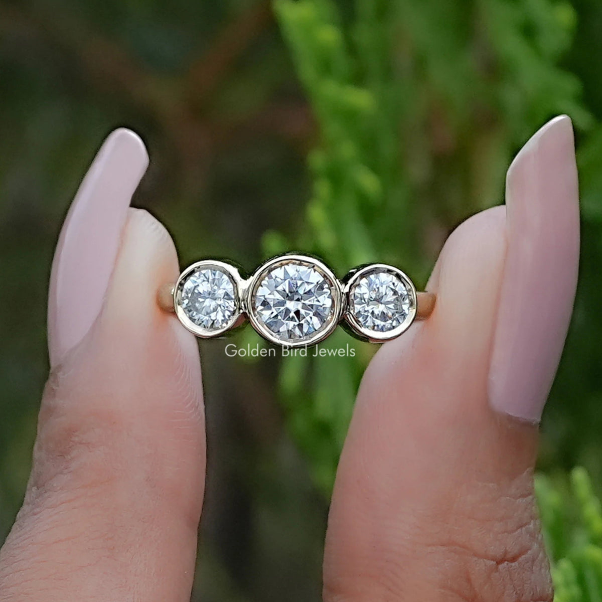 Front view of Round Moissanite Three Stone Bezel Set Ring