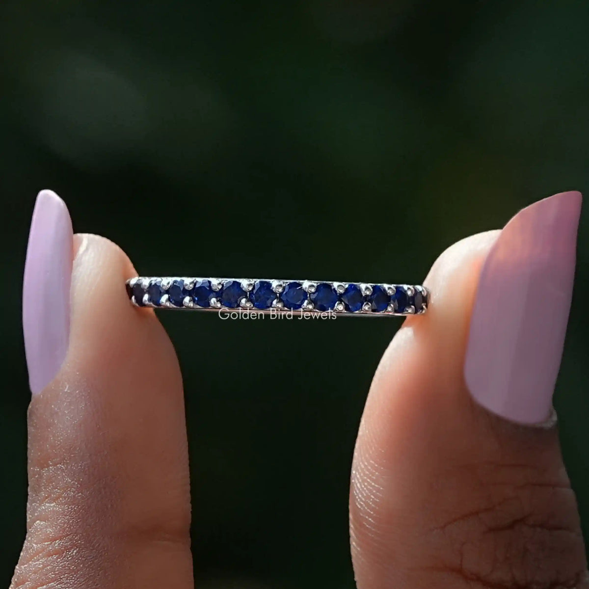 Front view of September Birthstone Sapphire Blue Round Eternity Band