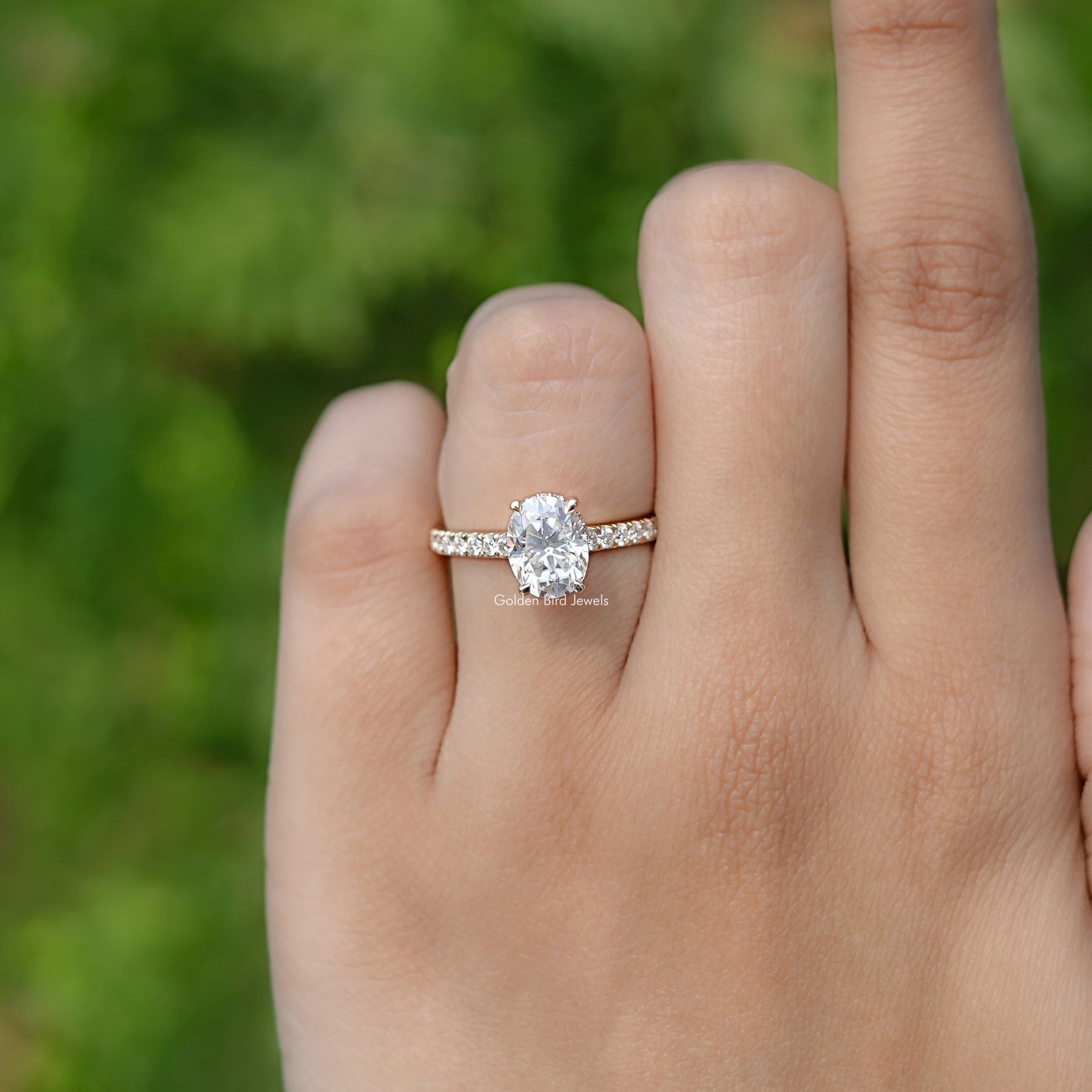In finger front view of Oval Moissanite Bridge Cut Moissanite ring