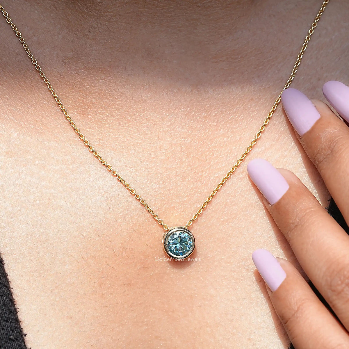 In neck view of aqua blue moissanite halo pendant