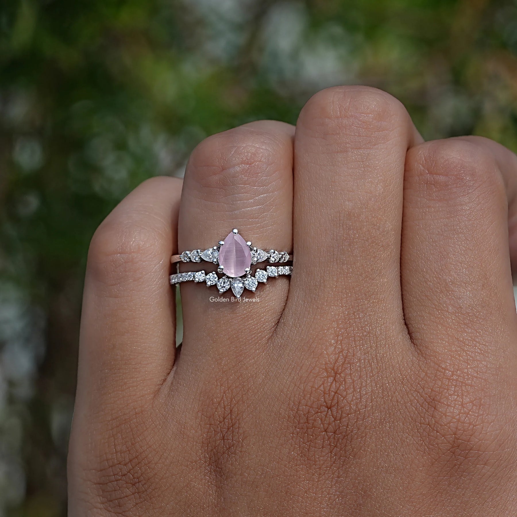 Pink Pear Cut Gemstone Halo Ring In finger