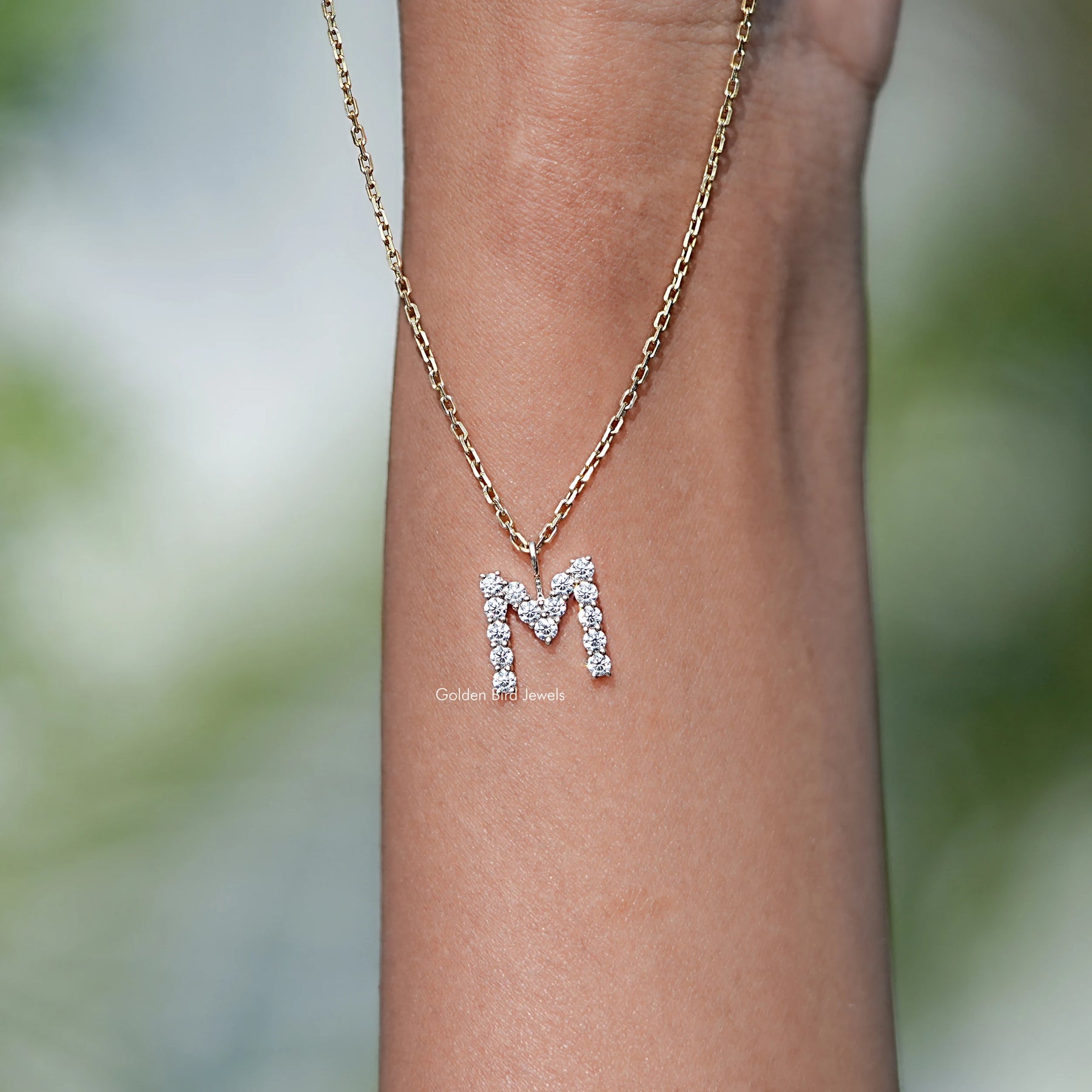 Close View Of M Letter moissanite pendant in Secure Setting