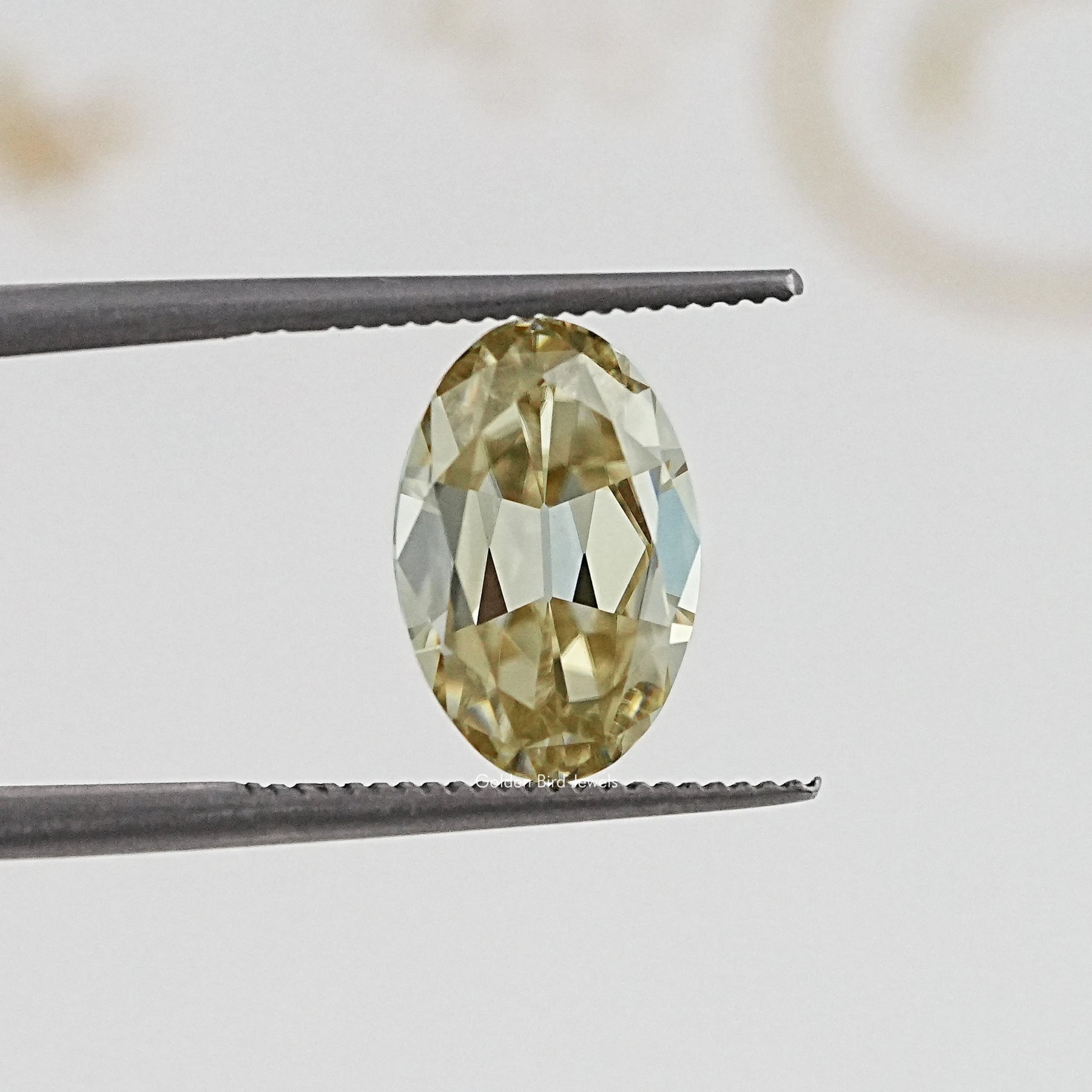 In Tweezer View Of Old Mine Oval Cut Loose Moissanite Stone