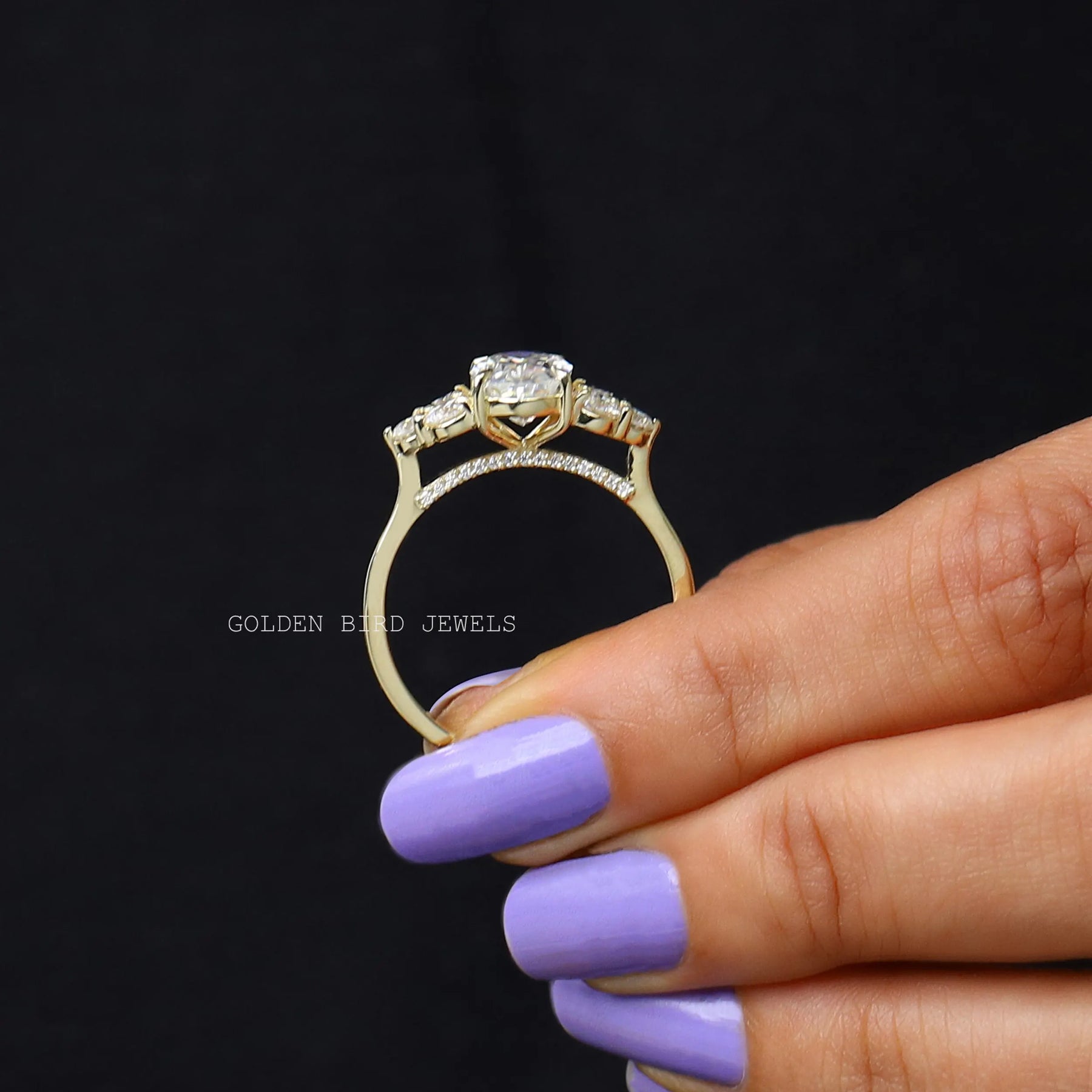 Back view of Oval crushed moissanite  engagement ring in two fingers