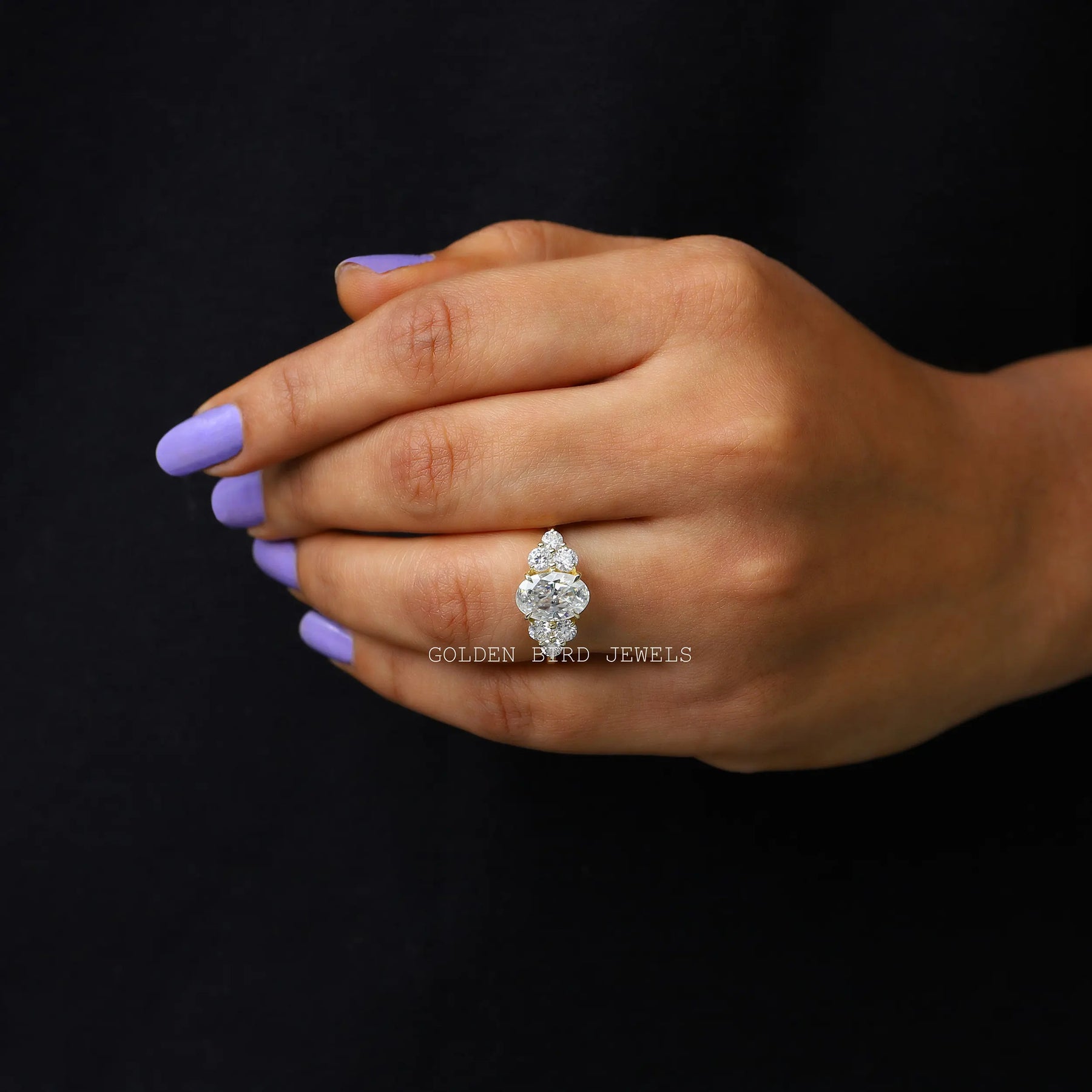 In finger front view of an oval moissanite  engagement  ring