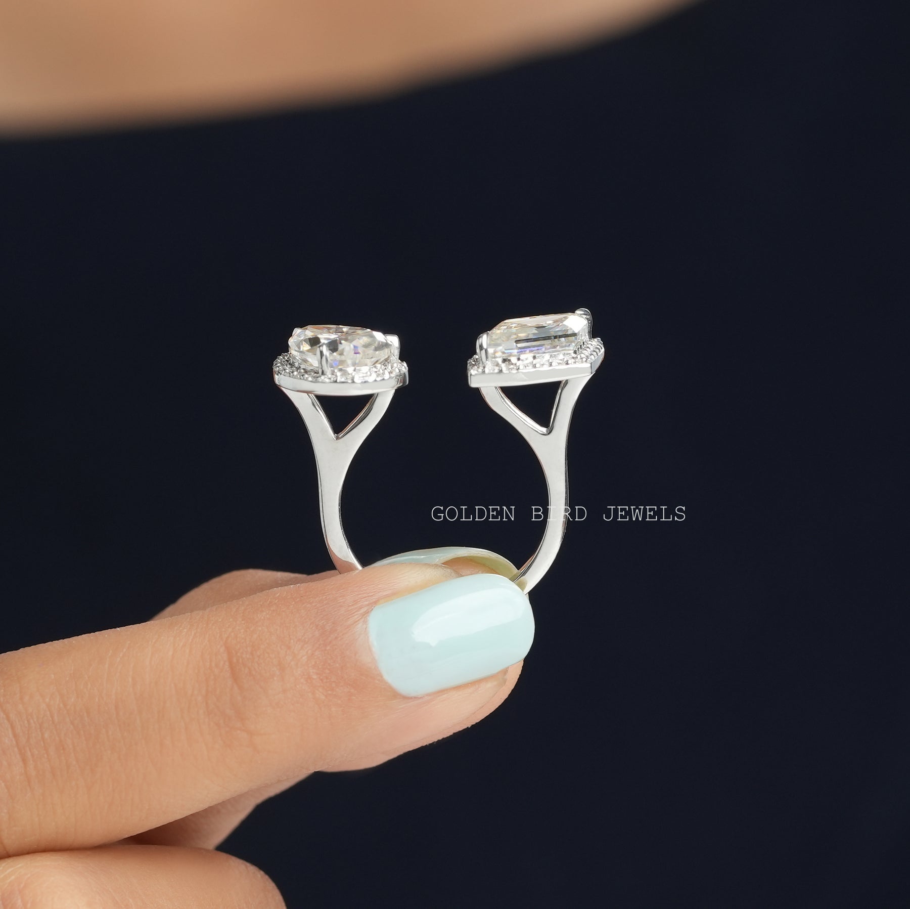 Two stone halo engagement ring on two fingers