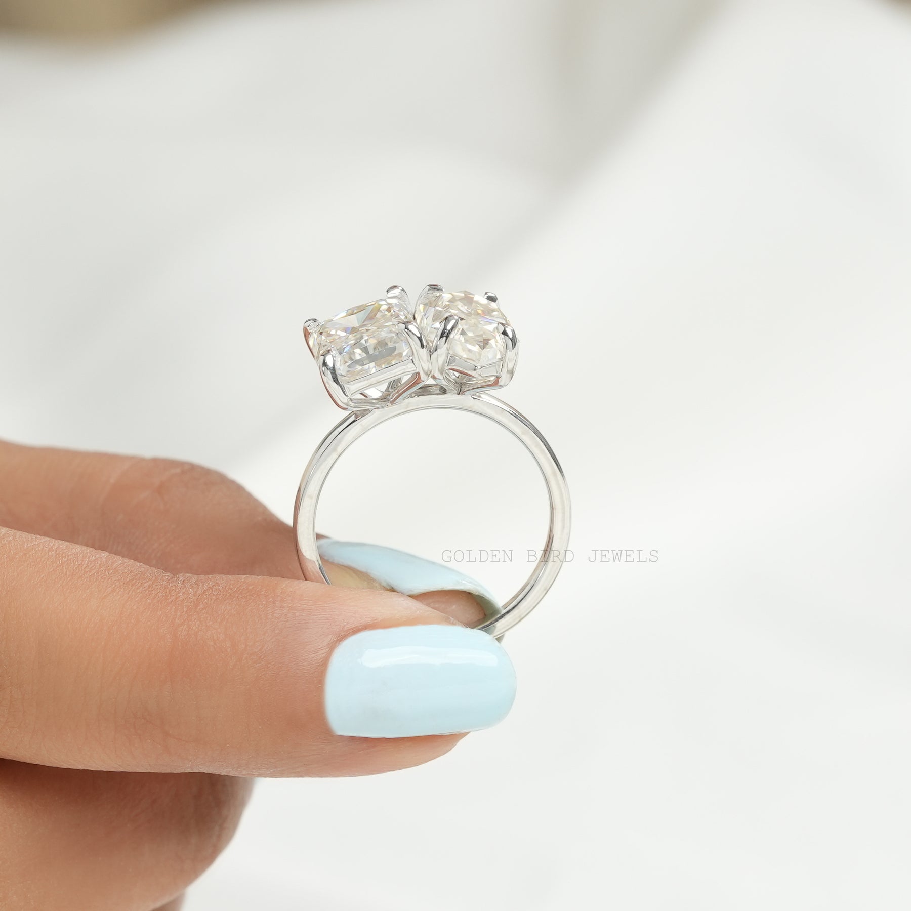 Back View of Dutch Marquise & Radiant Cut Moissanite Toi Et Moi Ring  In two fingers