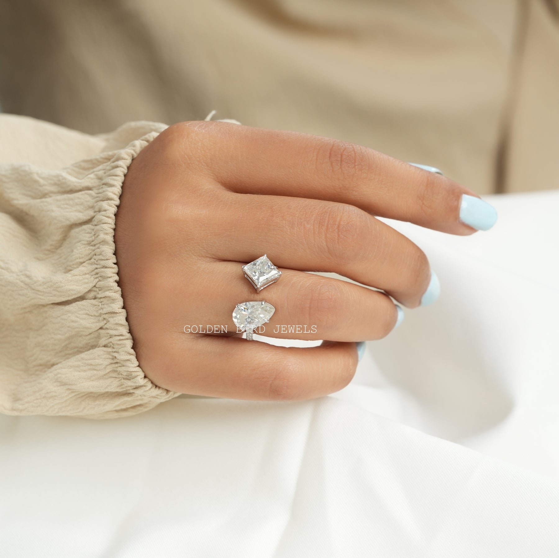 View of princess and pear cut moissanite toi moi ring In Finger