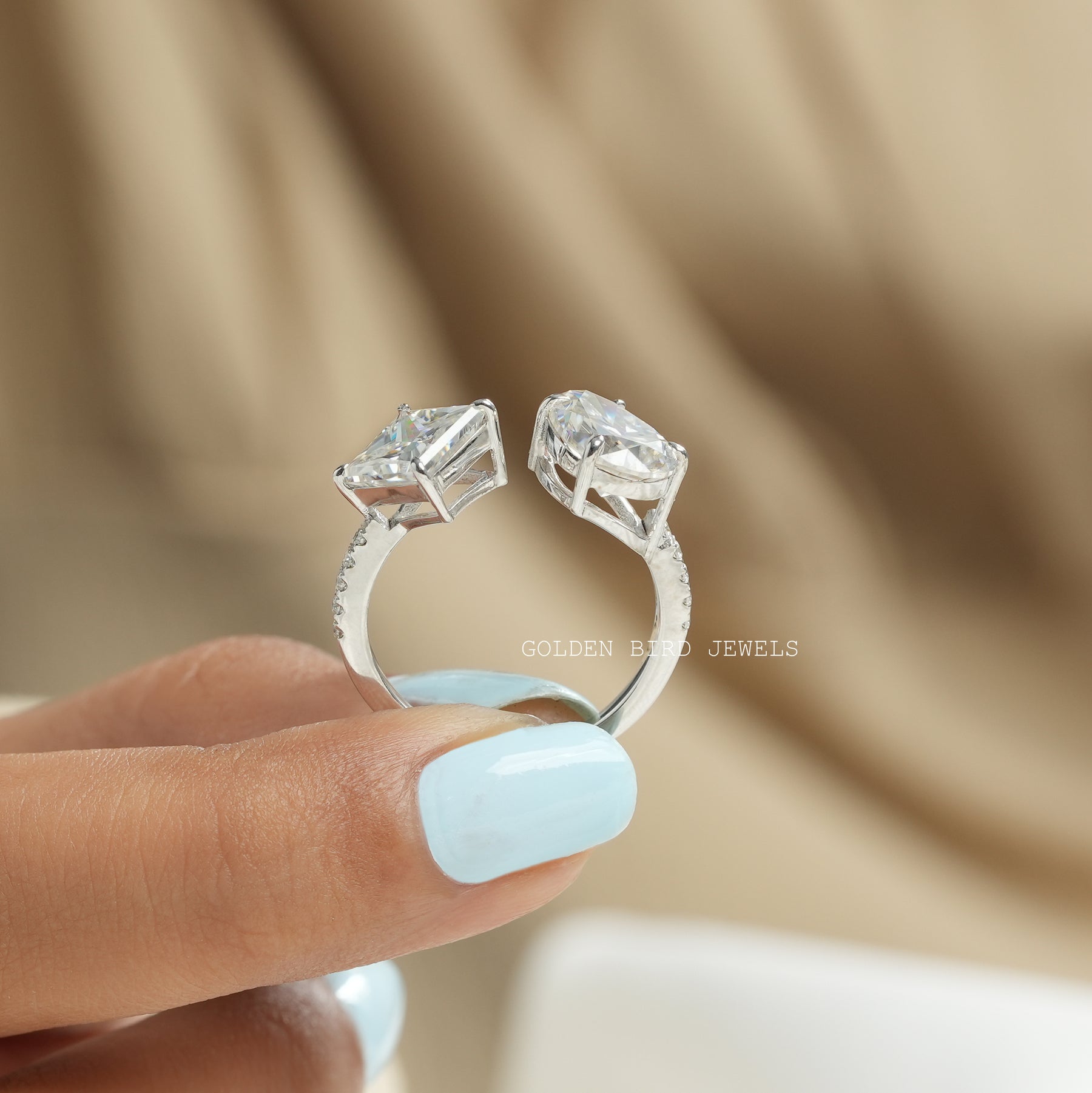 Back View of princess and pear cut moissanite toi moi ring In two fingers