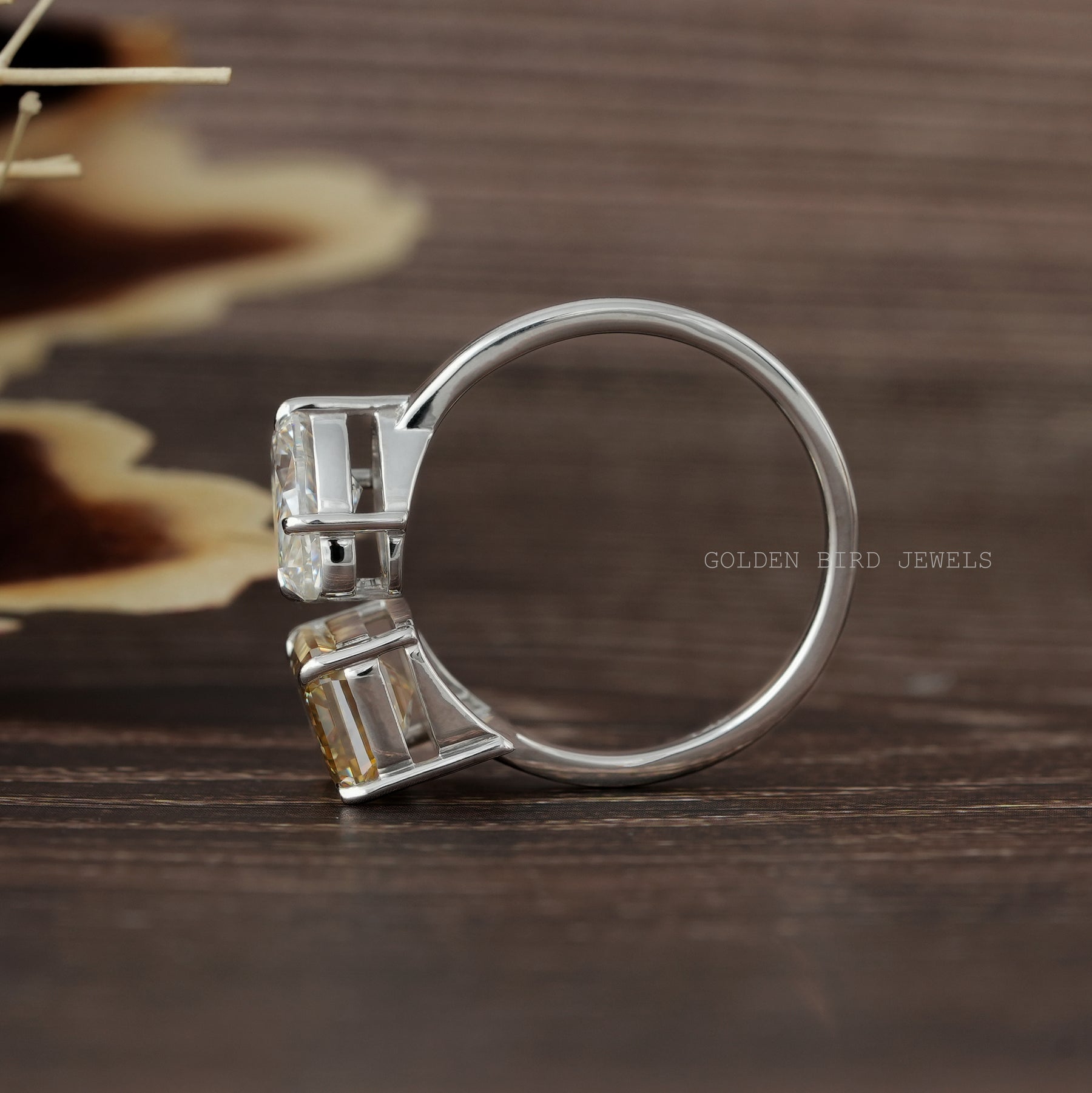 Back View of Pear Cut Emerald Toi Et Moi Ring In two fingers