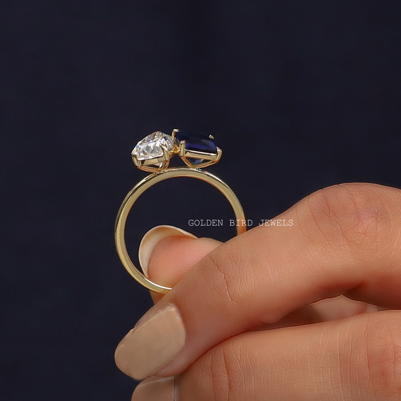 Back View of Two Stone Moissanite Engagement Ring In two fingers