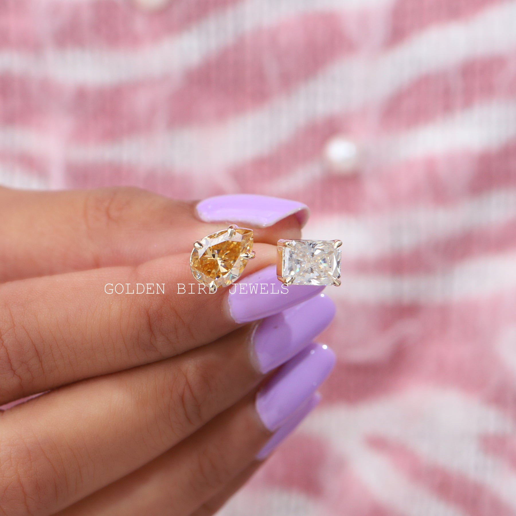 Top view of Moissanite ring holding on two fingers