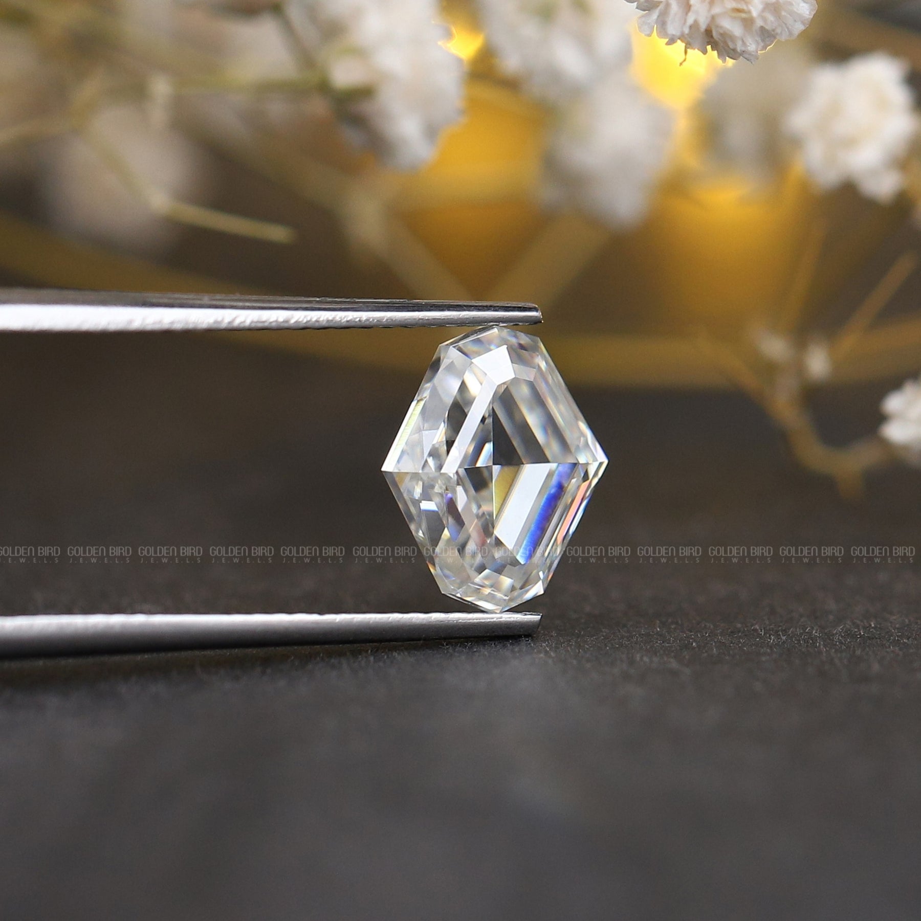 Tweezers holding the Colorless Moval Cut Loose Moissanite Stone