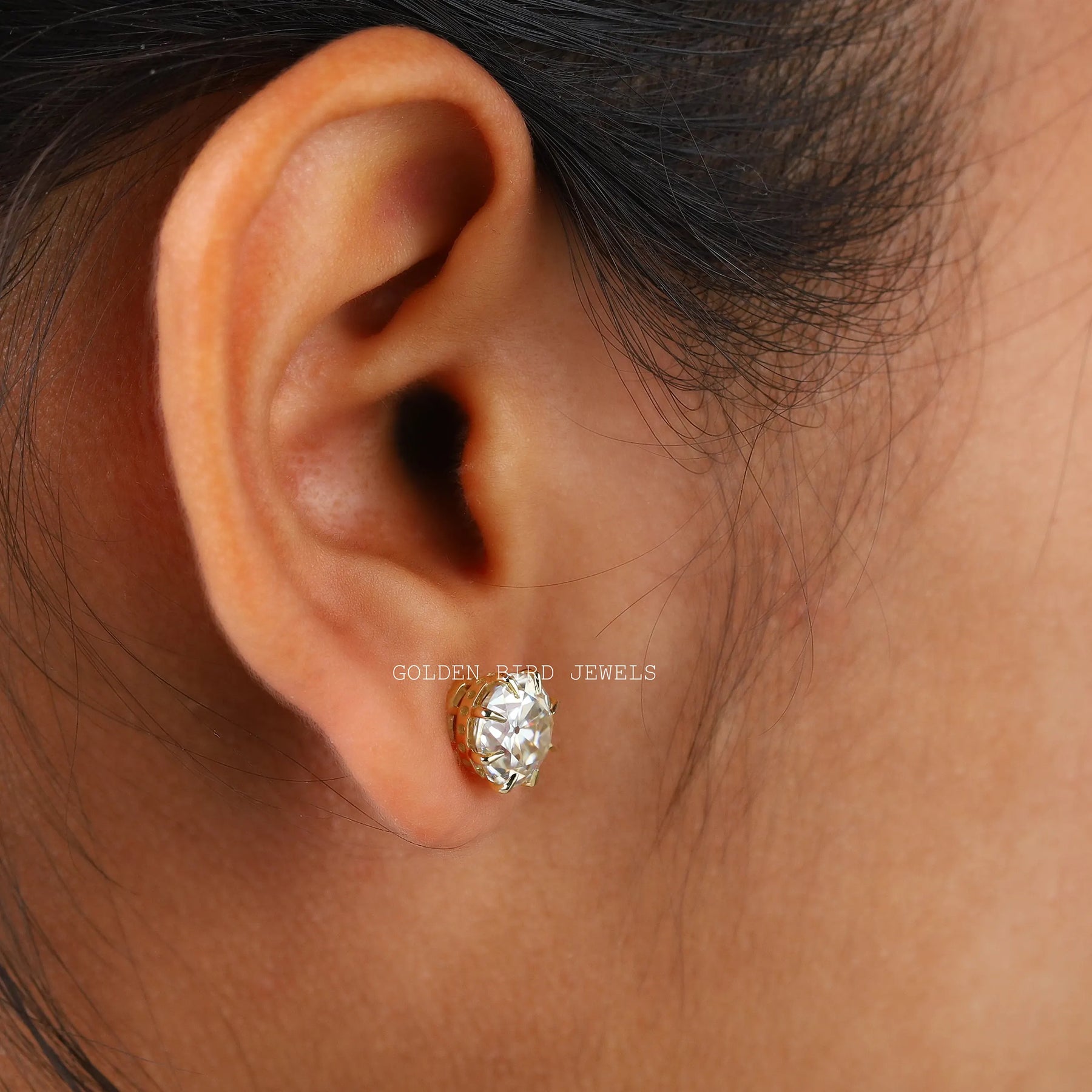Side view of stud earrings in white gold
