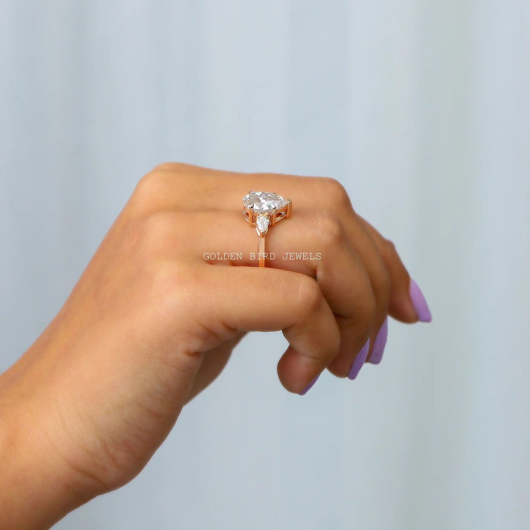 In finger view of a moissanite engagement ring in secure setting