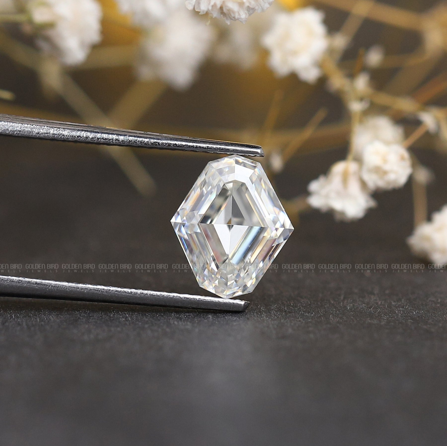 Tweezers holding the Step Cut Moval Loose Moissanite