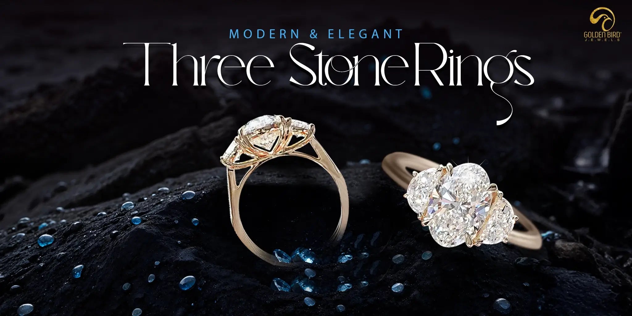 Three-stone engagement ring made by goldenbird jewels placed on black surface with glittering blue dew drops and text written"Elegamt and Modern- Three-stone engagement ring