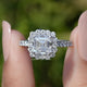 Front view of Asscher Cut Lab Diamond Accent Halo Wedding Ring in two fingers 