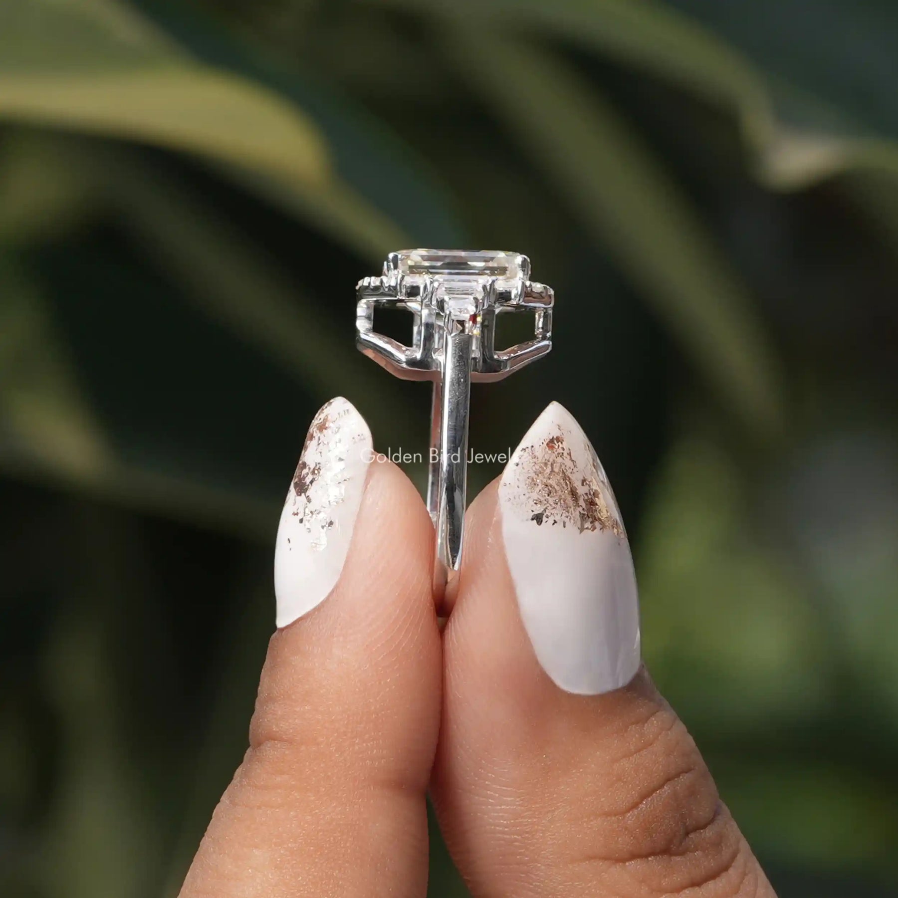 Side View of Asscher And Round Cut Moissanite Ring In two fingers