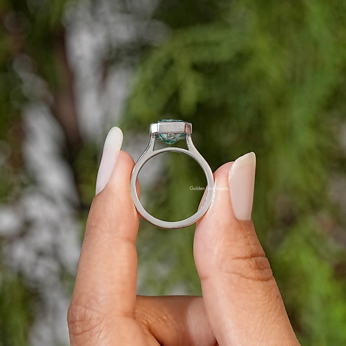 Teal emerald-cut moissanite solitaire ring back view, open bezel detail