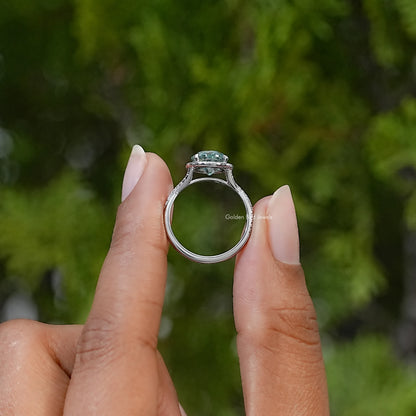 Side view of the silver halo ring showing its raised center stone and slender band