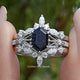 Front view of Blue Hexagon Gemstone Bridal Ring Set in two fingers 