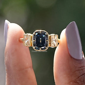 Two fingers holding the Old Mine Criss Cut Moissanite 3 Stone Ring