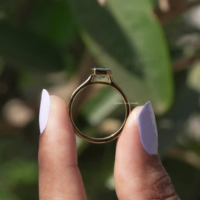 Back View of Radiant Cut Bezel Set Engagement Ring In two fingers