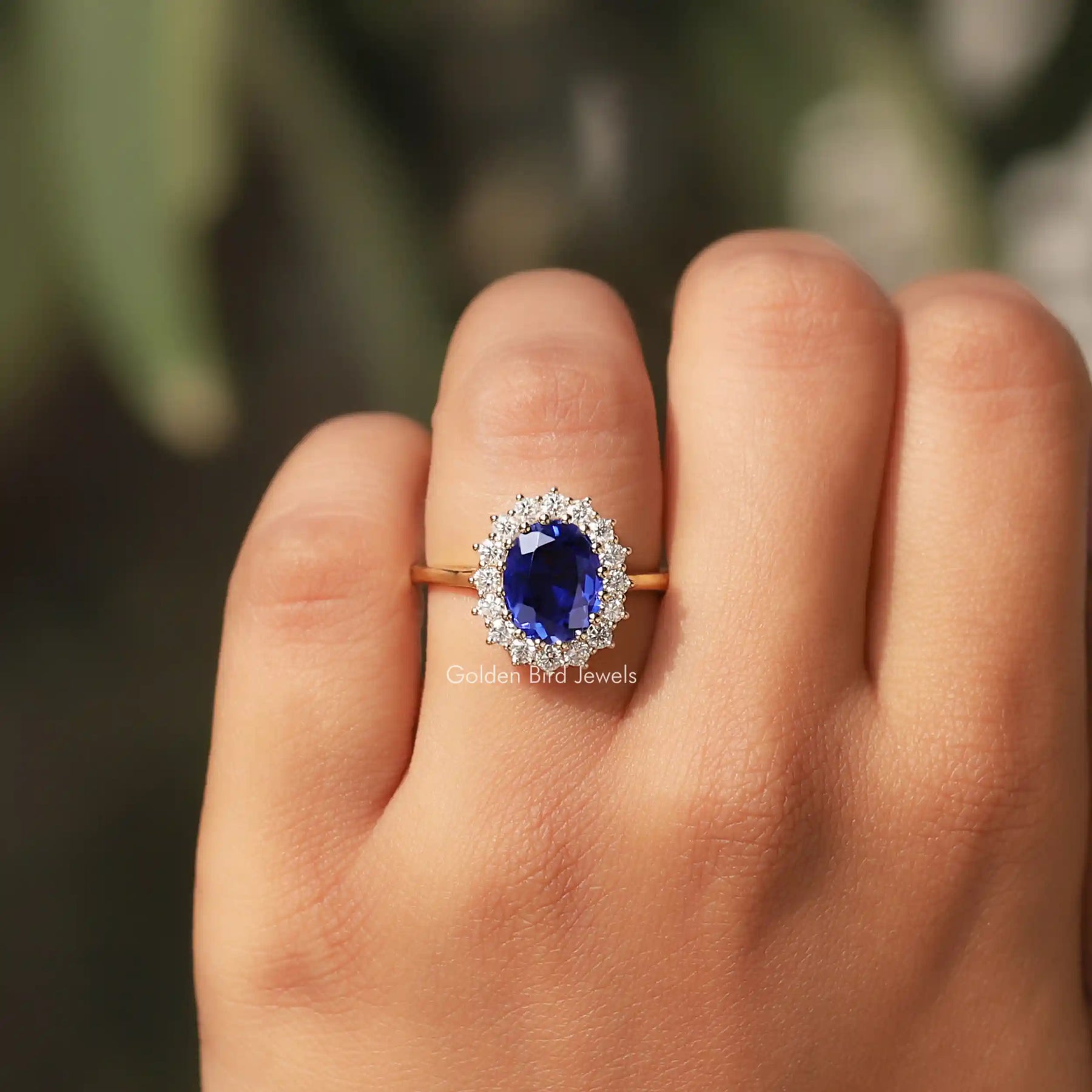 Detailed View Of Oval Cut Halo  Gemstone Ring In a finger