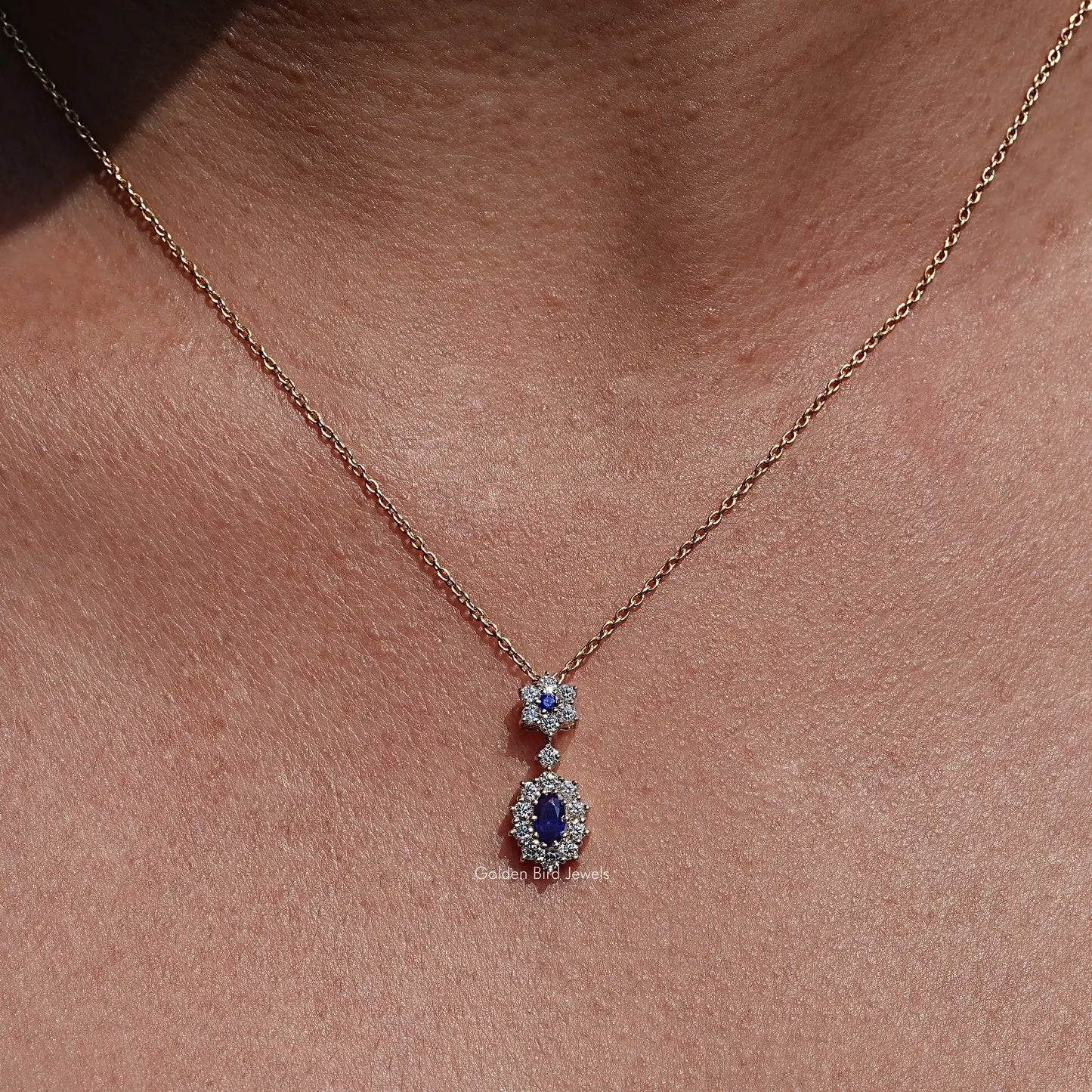 Front view of Blue Sapphire Oval Gemstone Halo Pendant In Women's 