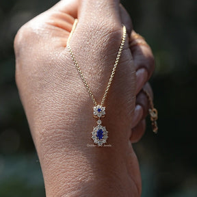 View of Blue Sapphire Oval Gemstone Halo Pendant in wear an hand