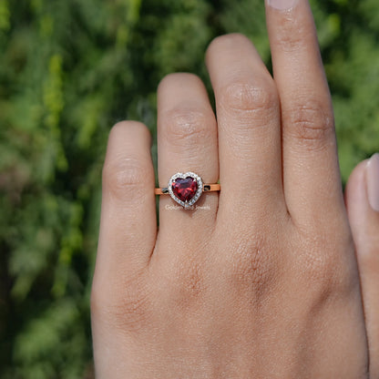 In finger front view of Red Ruby Heart engagement ring 
