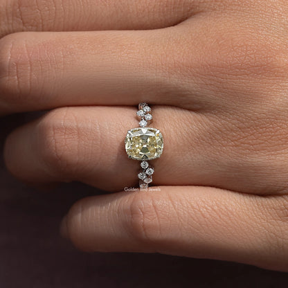 Sterling silver ring with yellow cushion-cut moissanite center and small round accents