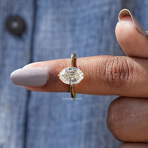 In finger front View of Oval Cut Moissanite Ring In Yellow Gold