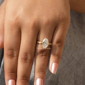 Close-Up View of Moval Cut Moissanite Engagement Ring In Yellow Gold