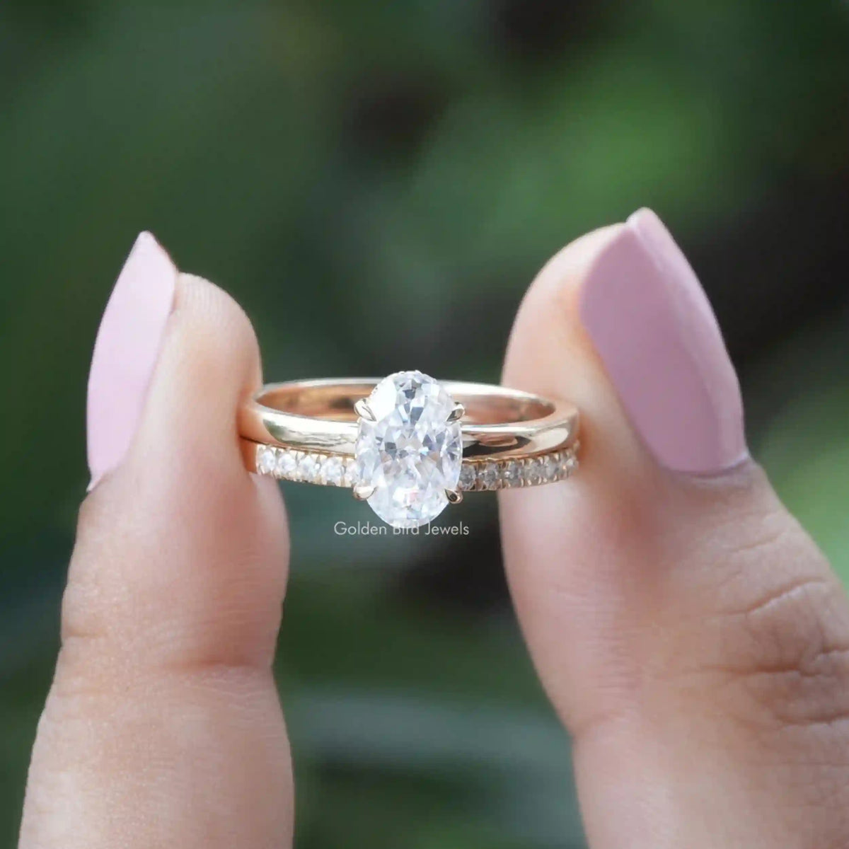 Front View of Oval Cut Moissanite Hidden Halo Ring In two Fingers