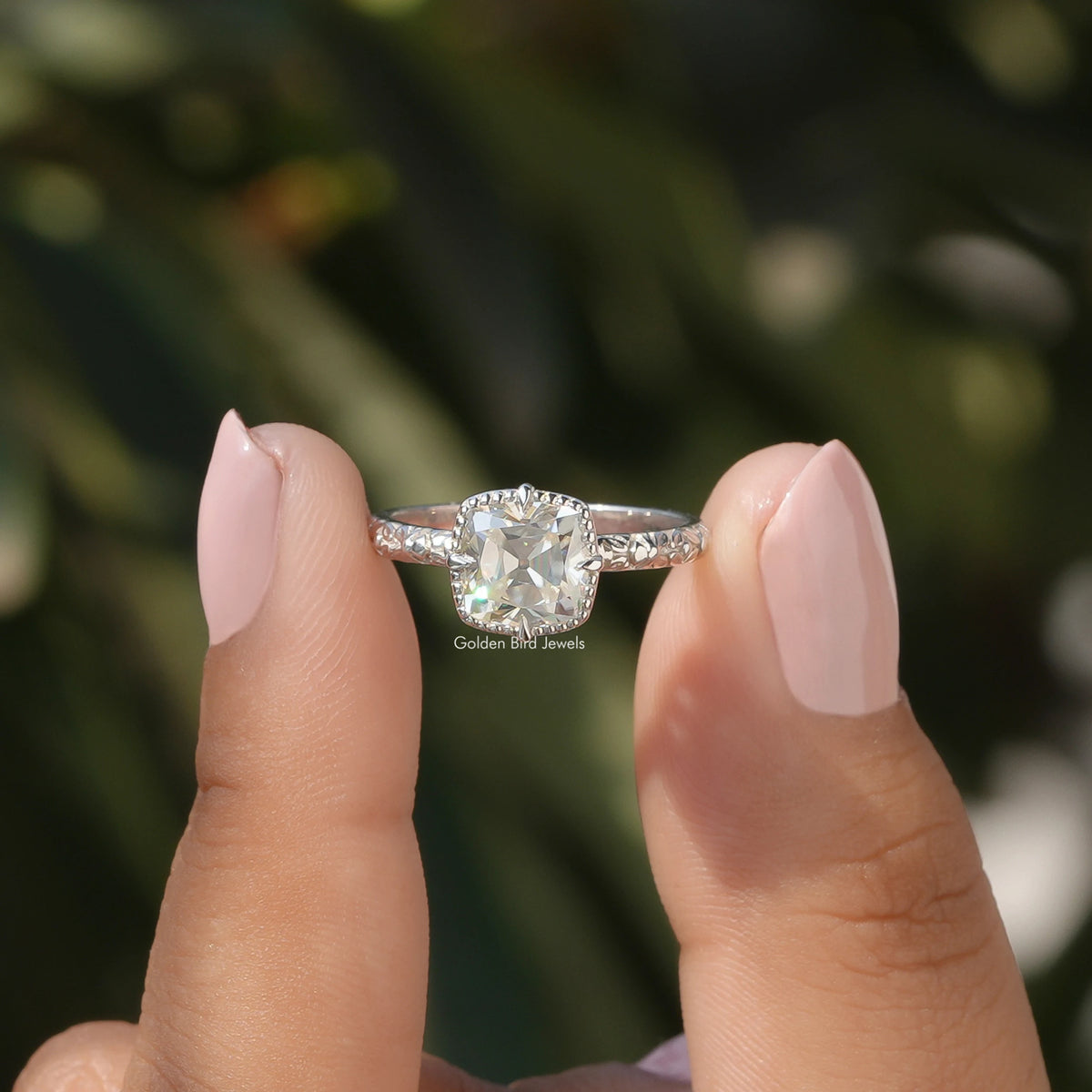 Two fingers holding the Peruzzi Cut Moissanite Solitaire Ring