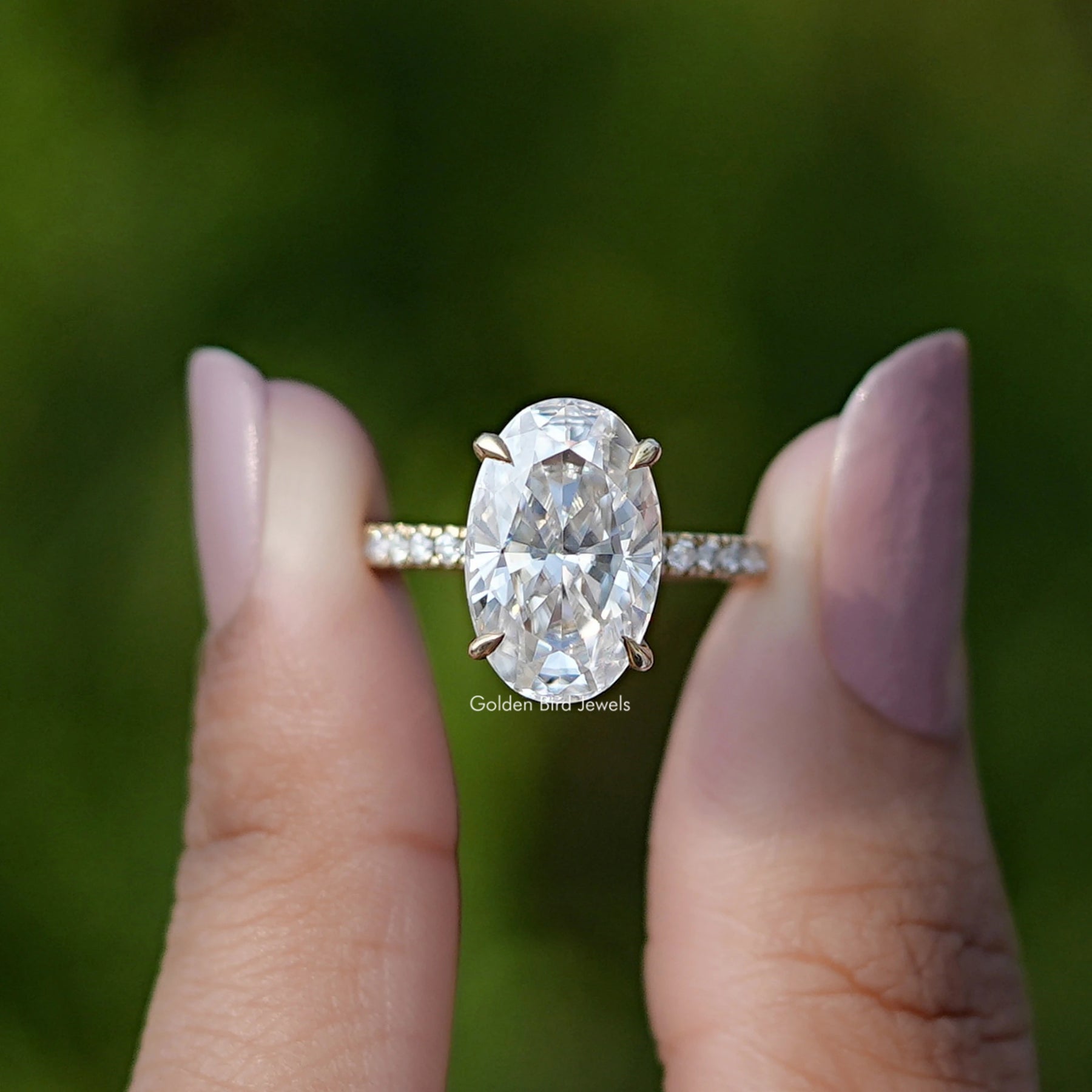 Front View of Oval Cut Moissanite Solitaire Ring In two Fingers