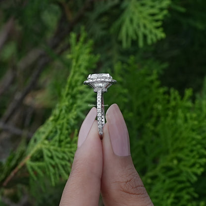 Side View of Cushion Cut Lab Diamond Halo Engagement Ring In two fingers